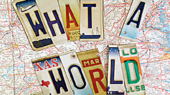 Collage of license plate letters spelling "WHAT A WORLD" atop a detailed map of the United States.