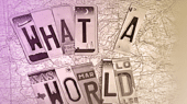 Letters made from vehicle license plates arranged on a map to form the phrase "WHAT A WORLD.