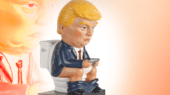 A figurine depicting a man with blonde hair and a business suit sitting on a toilet while holding a smartphone. A larger blurred image of the figurine is in the background.