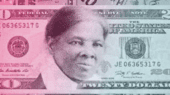 A $20 bill featuring a portrait of Harriet Tubman with multiple other dollar bills in the background.