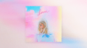 A colorful image featuring a woman with blonde hair wearing a white top. The word "Lover" is written above her in cursive. The background has pink and blue pastel shades.