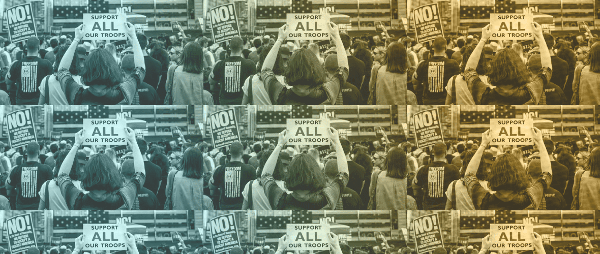 A group of people holding signs in front of an american flag.