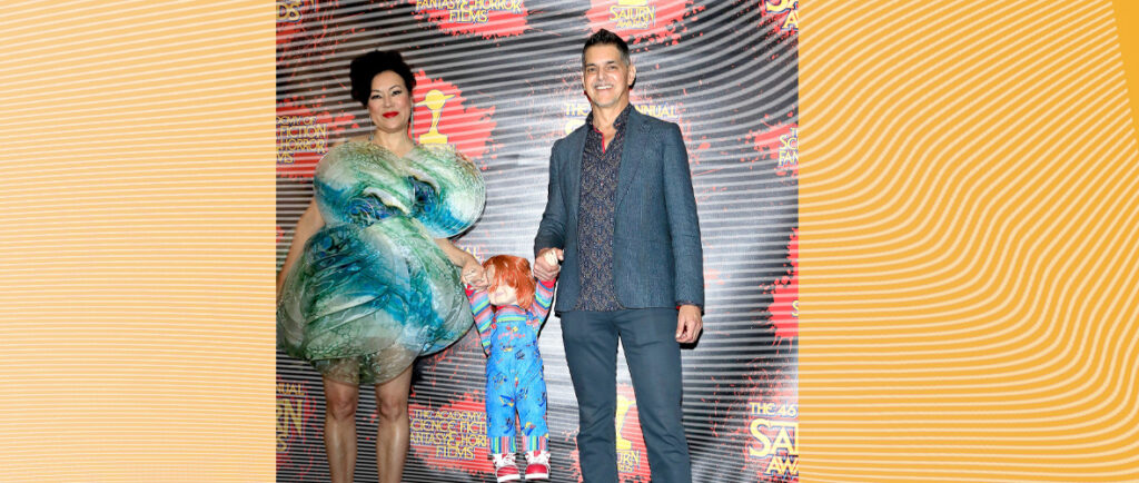 Celebrity couple with a doll