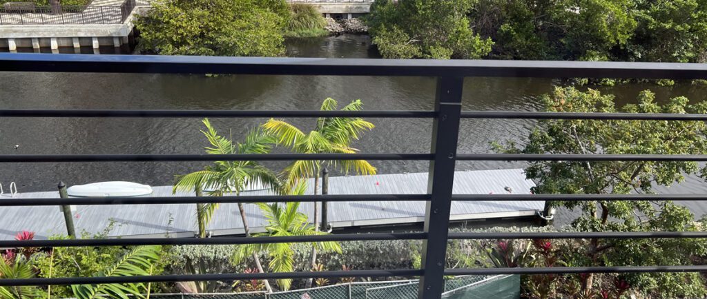 A view of trees and water from the balcony.